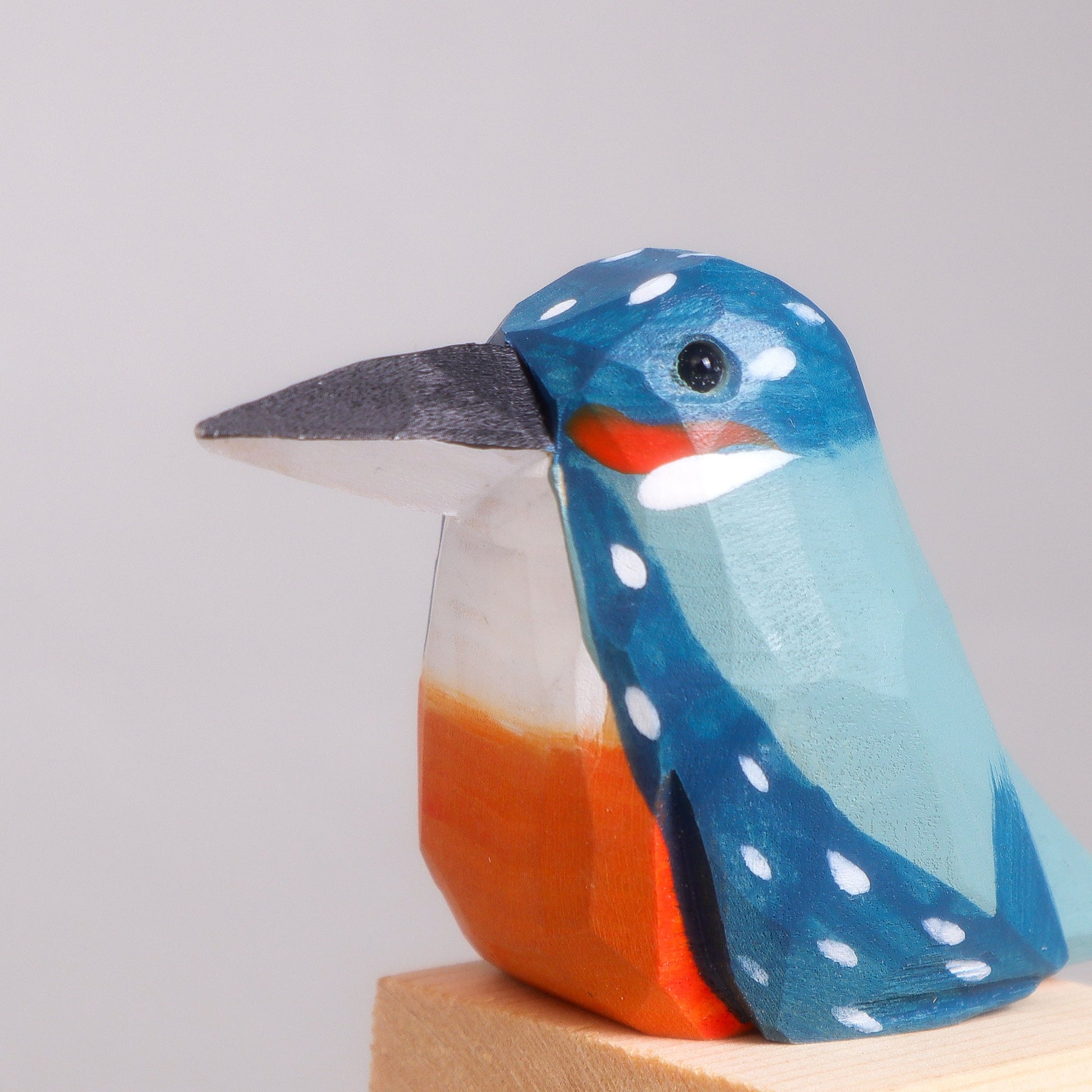 Wooden bird figurine on a white background