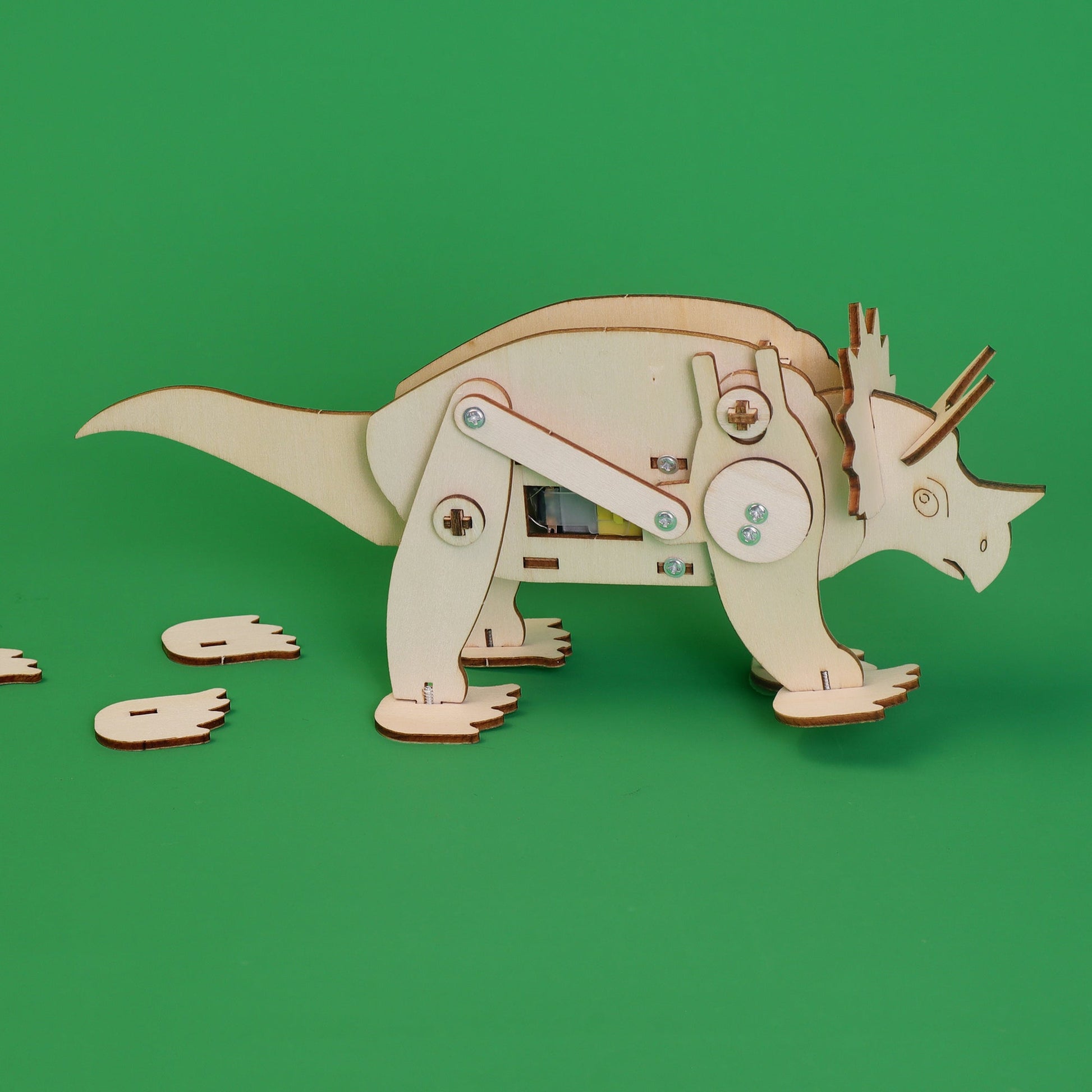 Wooden dinosaur model on a green background