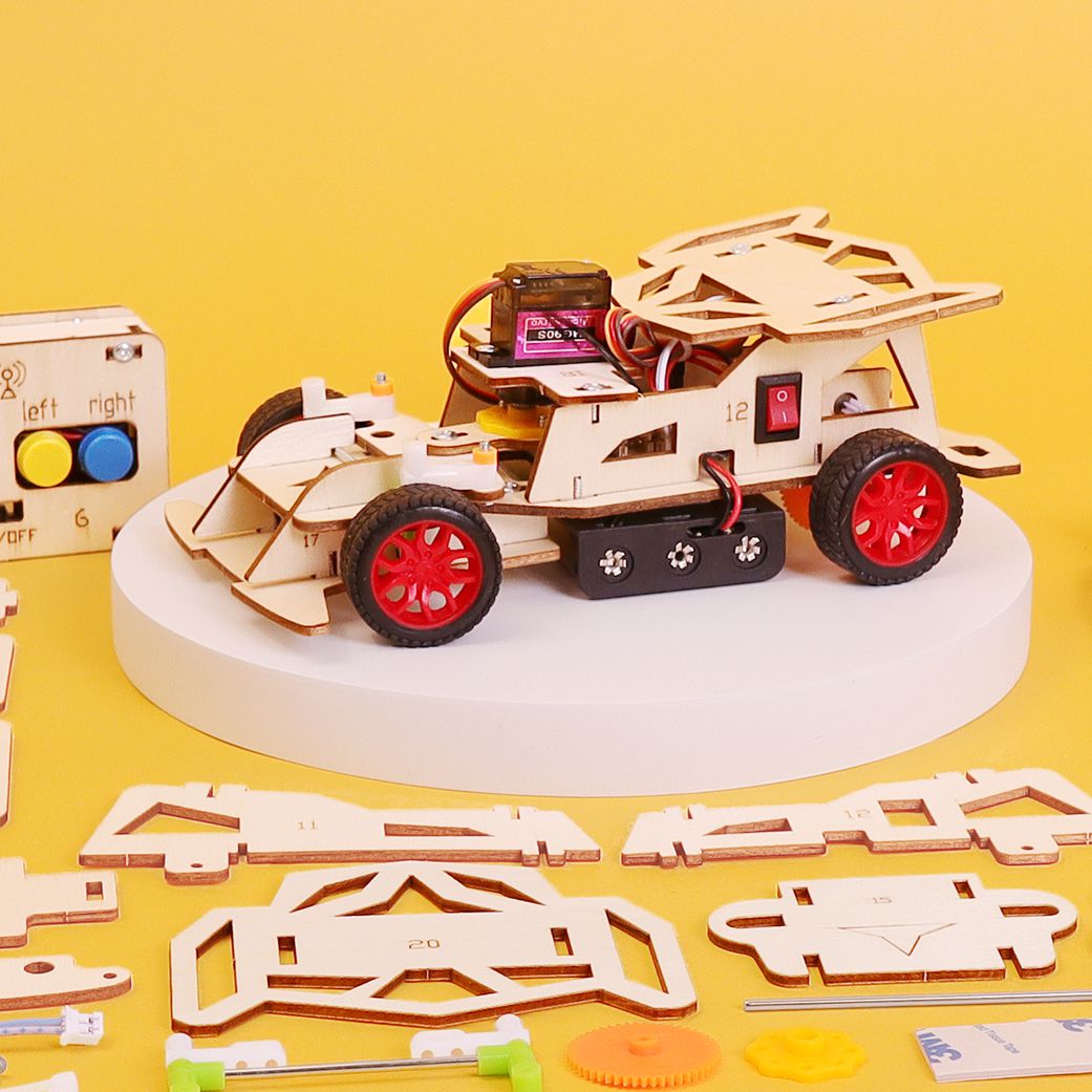Wooden toy car kit with red wheels on a yellow background