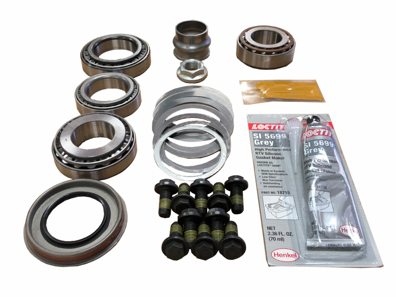 Mechanical bearing kit with seals, bolts, and a tube of grease on a white background