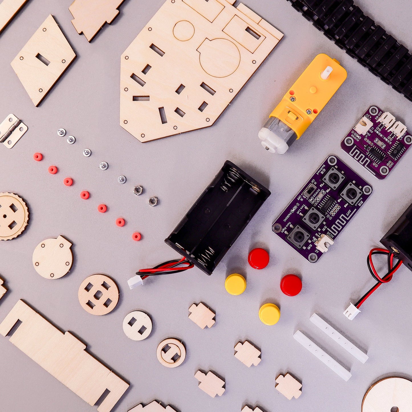 Assorted electronic components and wooden parts on a gray surface