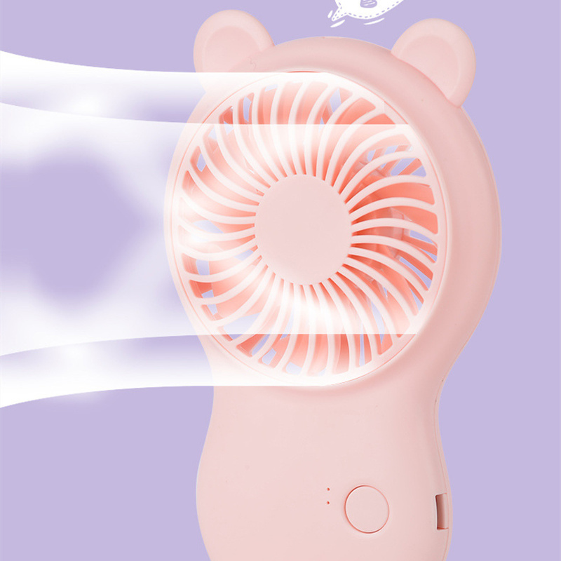 Pink handheld fan with bear ears on a light purple background