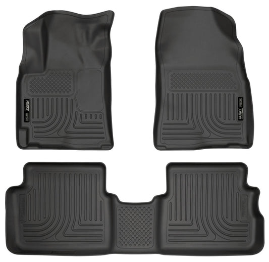 Set of four black car floor mats on a white background