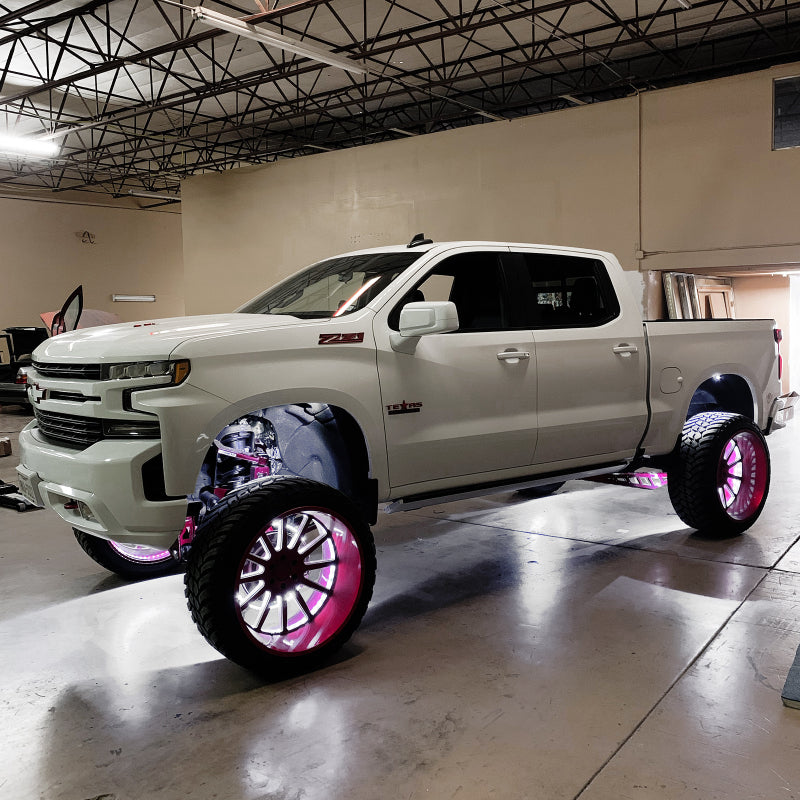 White pickup truck with pink underbody lighting