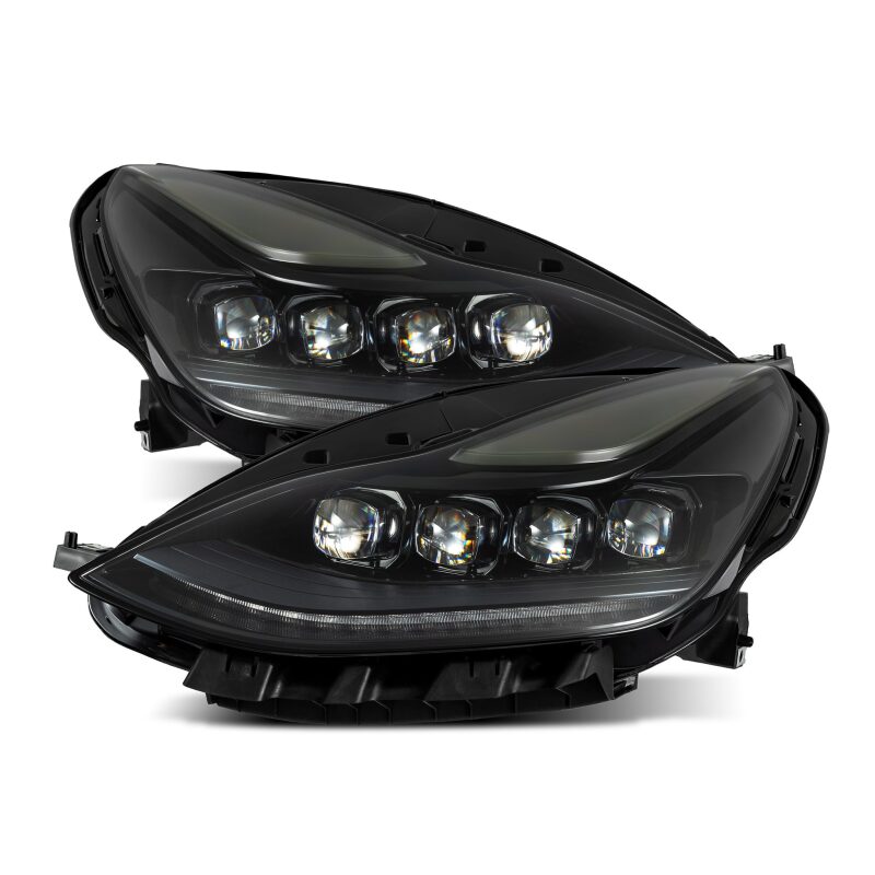 Pair of black car headlights on a white background
