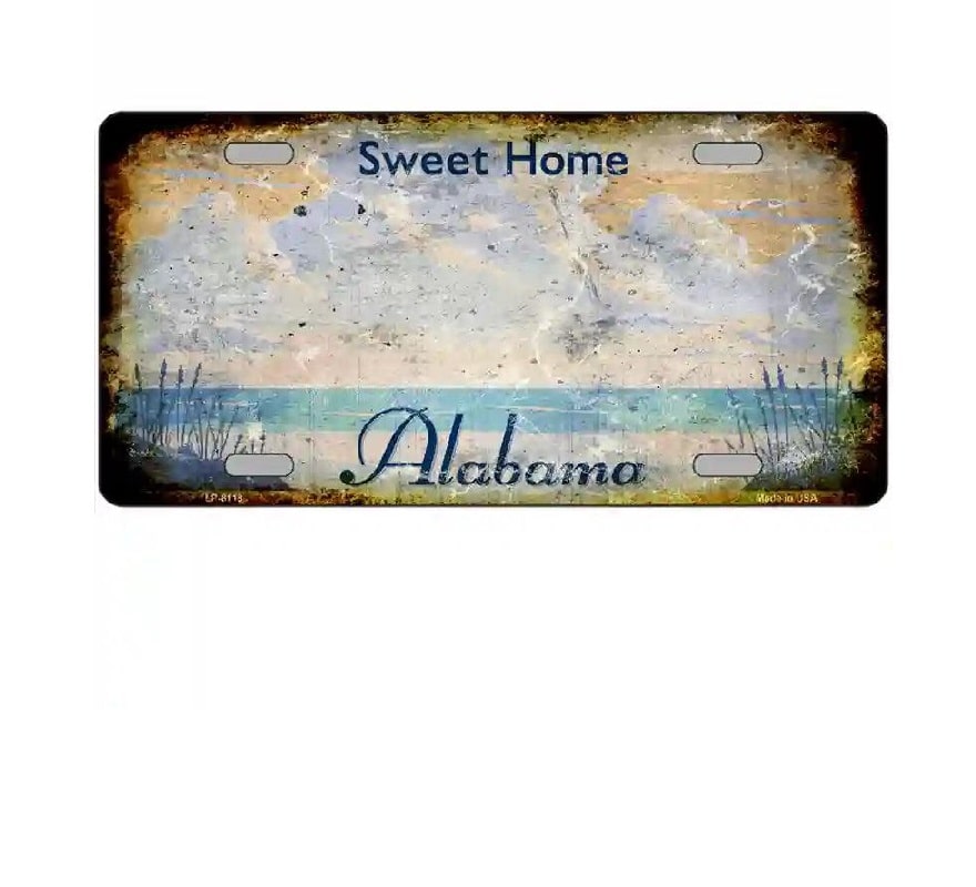 Decorative license plate with 'Sweet Home Alabama' text and beach scene design.