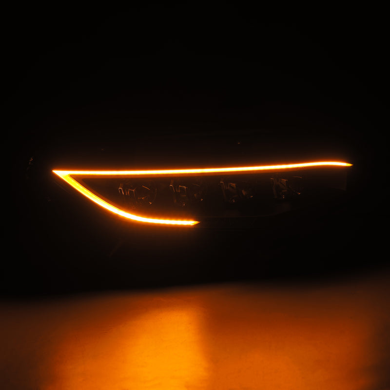 Close-up of a car headlight with orange light on a dark background