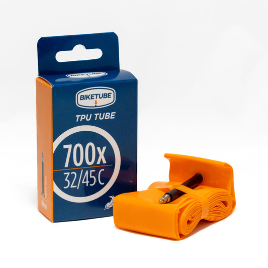 Orange bicycle tube with packaging on a white background