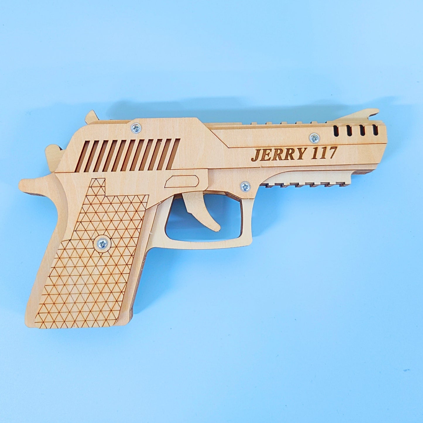 Wooden gun-shaped object with 'JERRY 117' engraving on a blue background