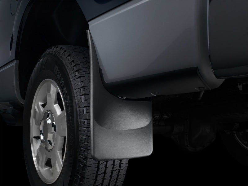 Car mud flap attached to a vehicle tire