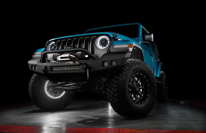Blue Jeep Wrangler on a dark background with underbody lighting