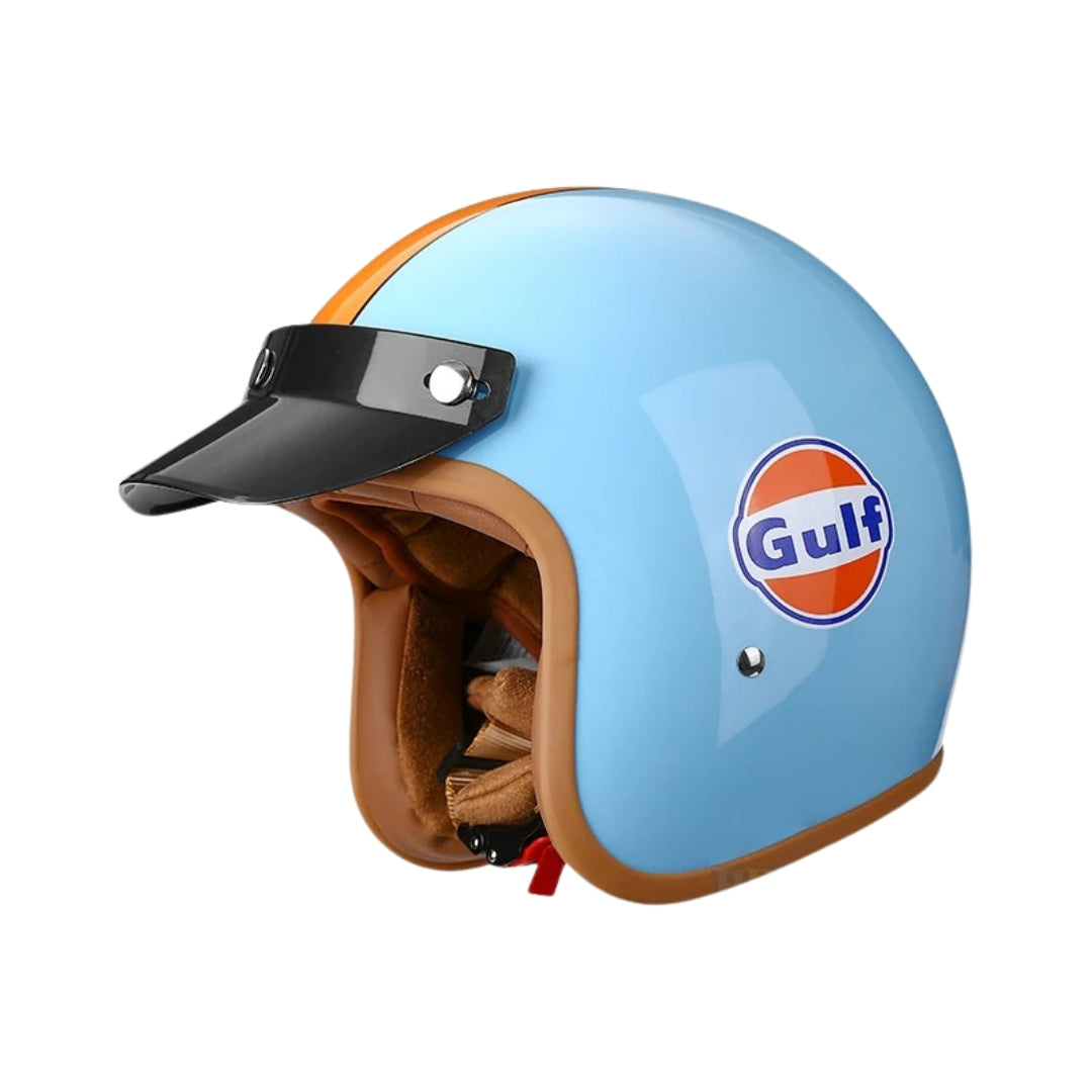 Light blue motorcycle helmet with brown visor and Gulf logo on a white background
