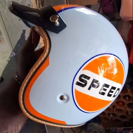 Vintage-style helmet with 'SPEED' logo on a reflective surface