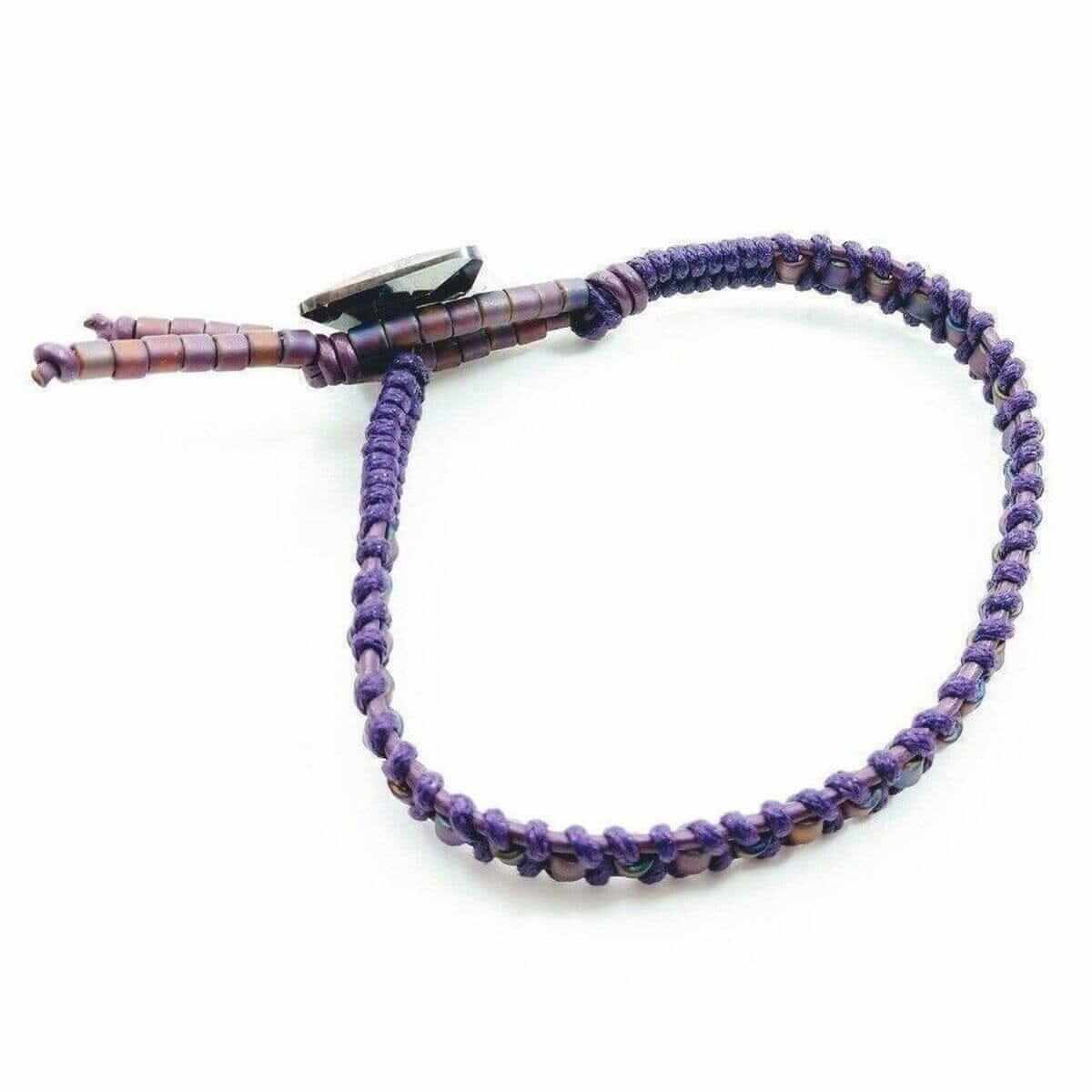 Purple braided bracelet on a white background