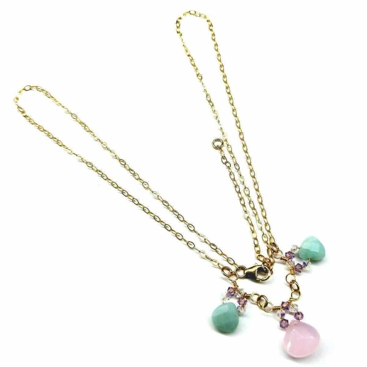 Gold necklace with colorful beads on a white background