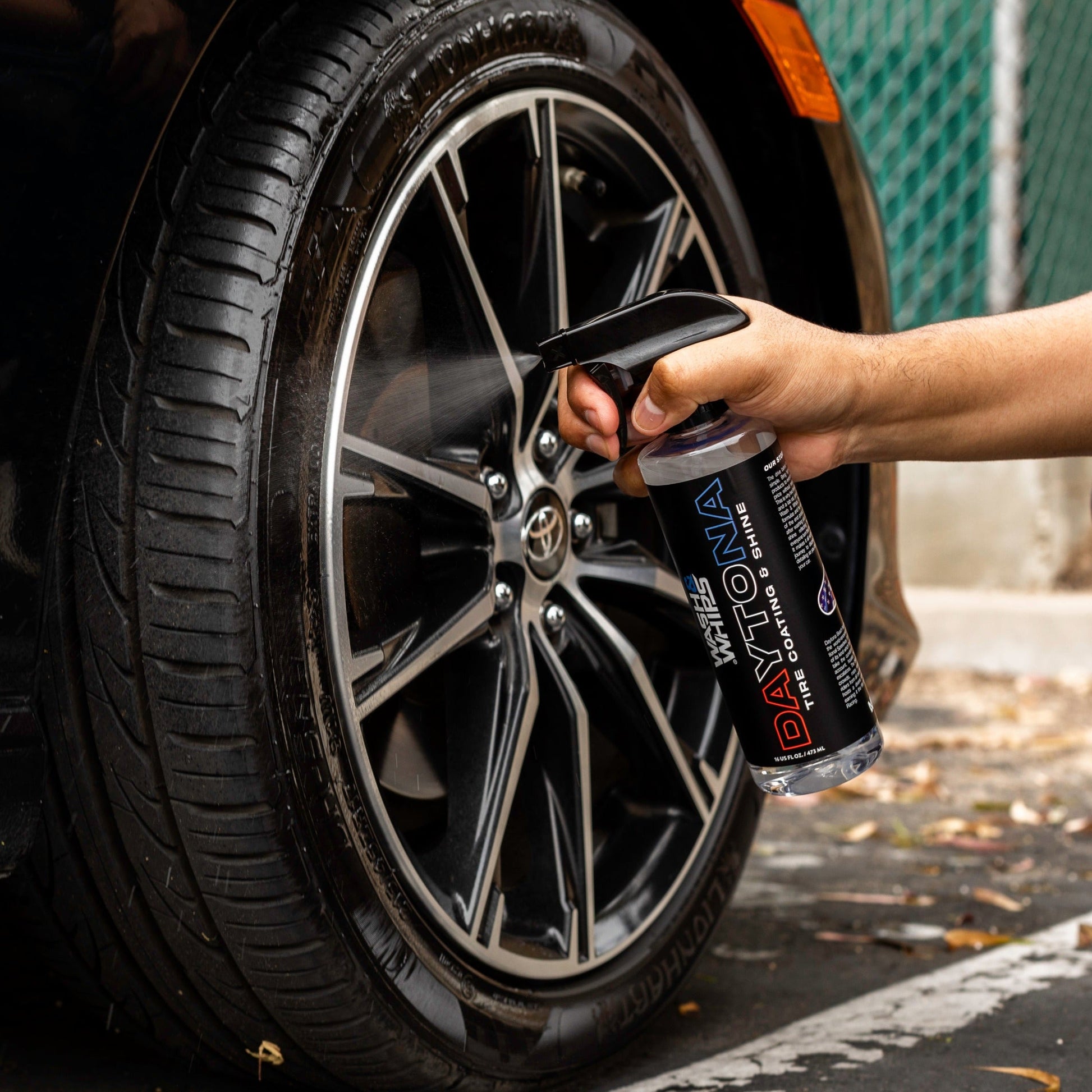 Person applying a tire coating product to a car tire
