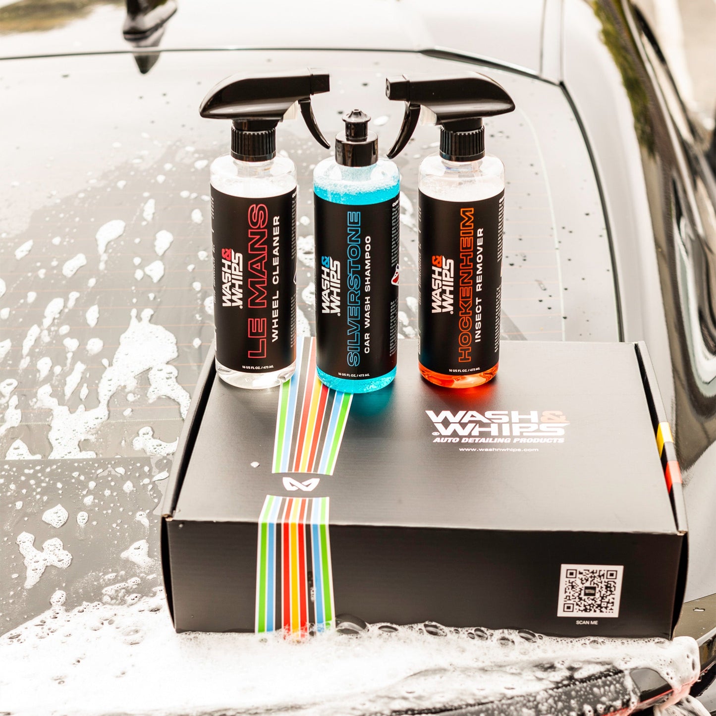 Three car care products on a box with a car wash background