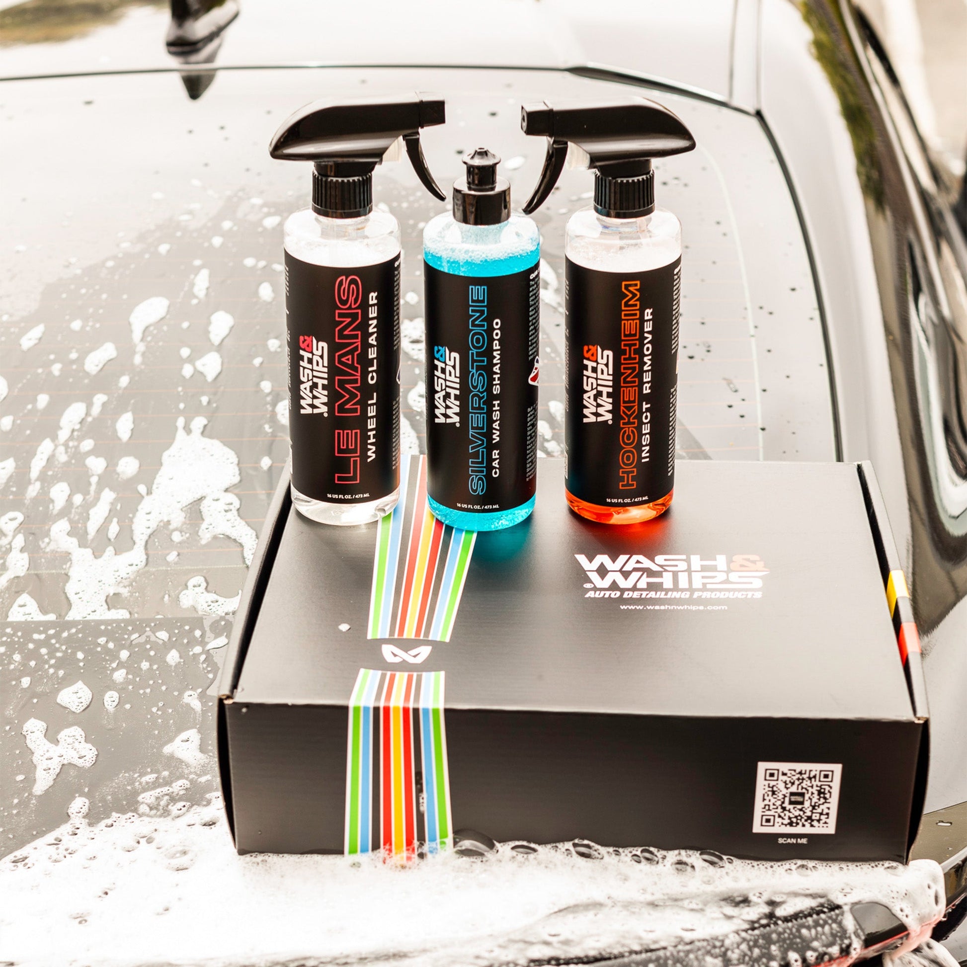 Three car care products on a box with a car wash background