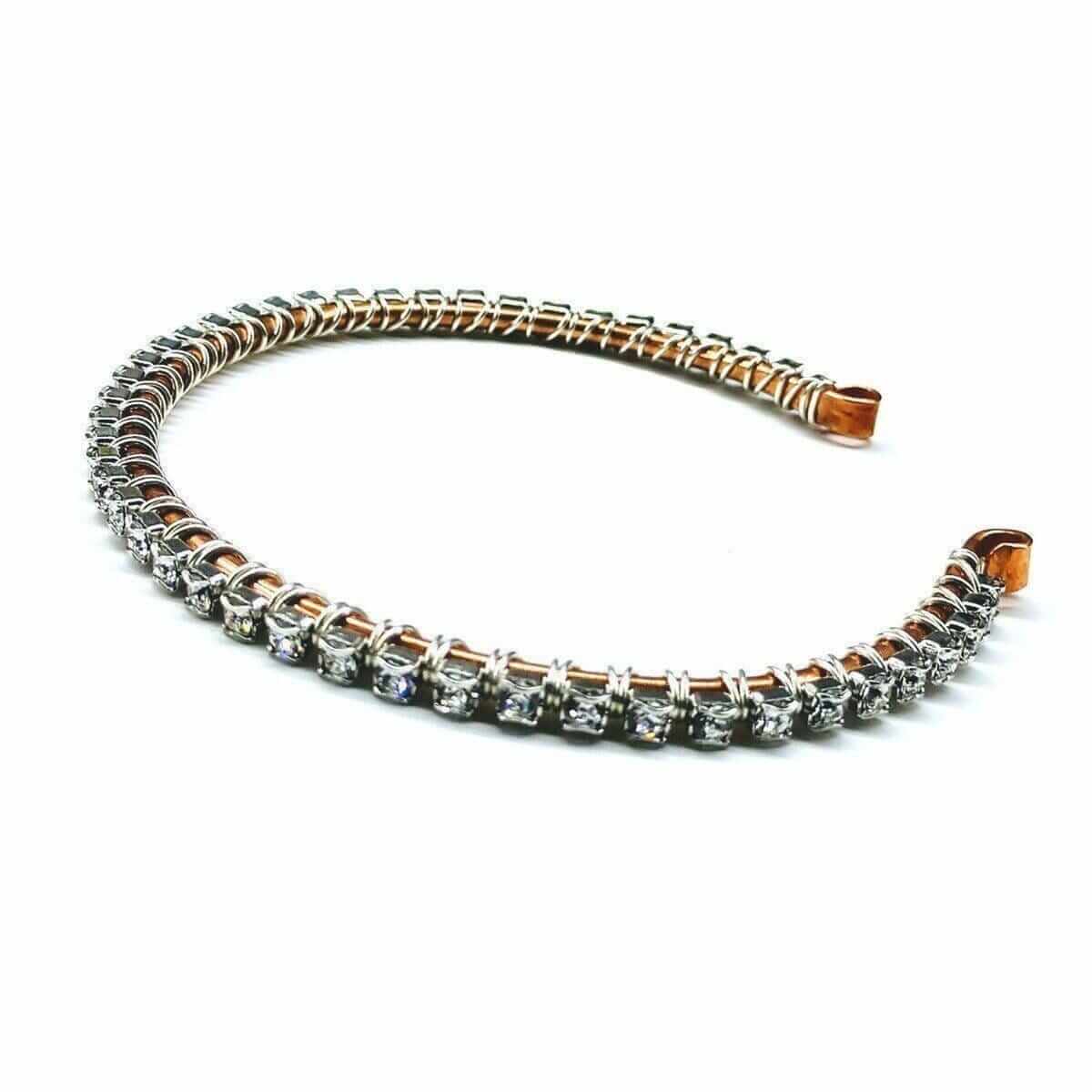 Bracelet with rose gold and silver accents on a white background