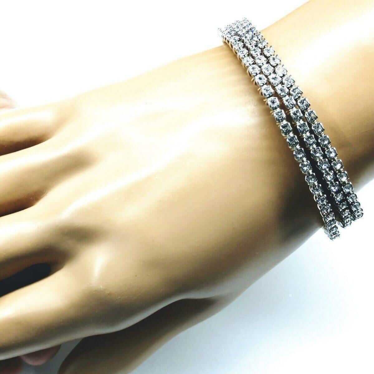 Silver bracelet on a mannequin hand against a white background