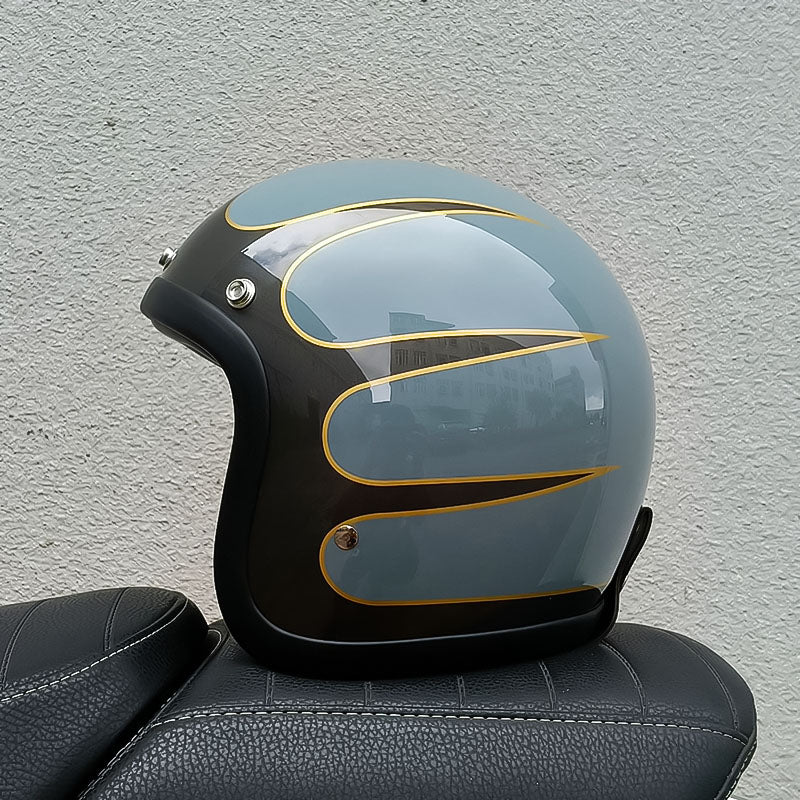 Motorcycle helmet with gold accents on a textured wall background