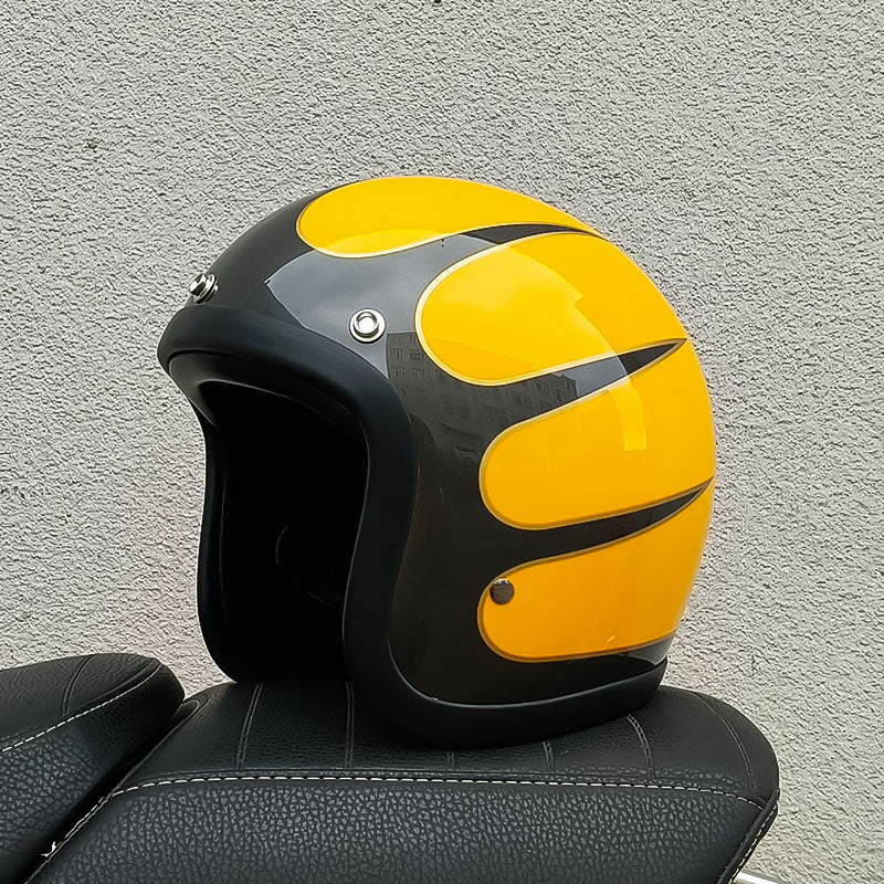 Black and yellow motorcycle helmet on a textured gray background