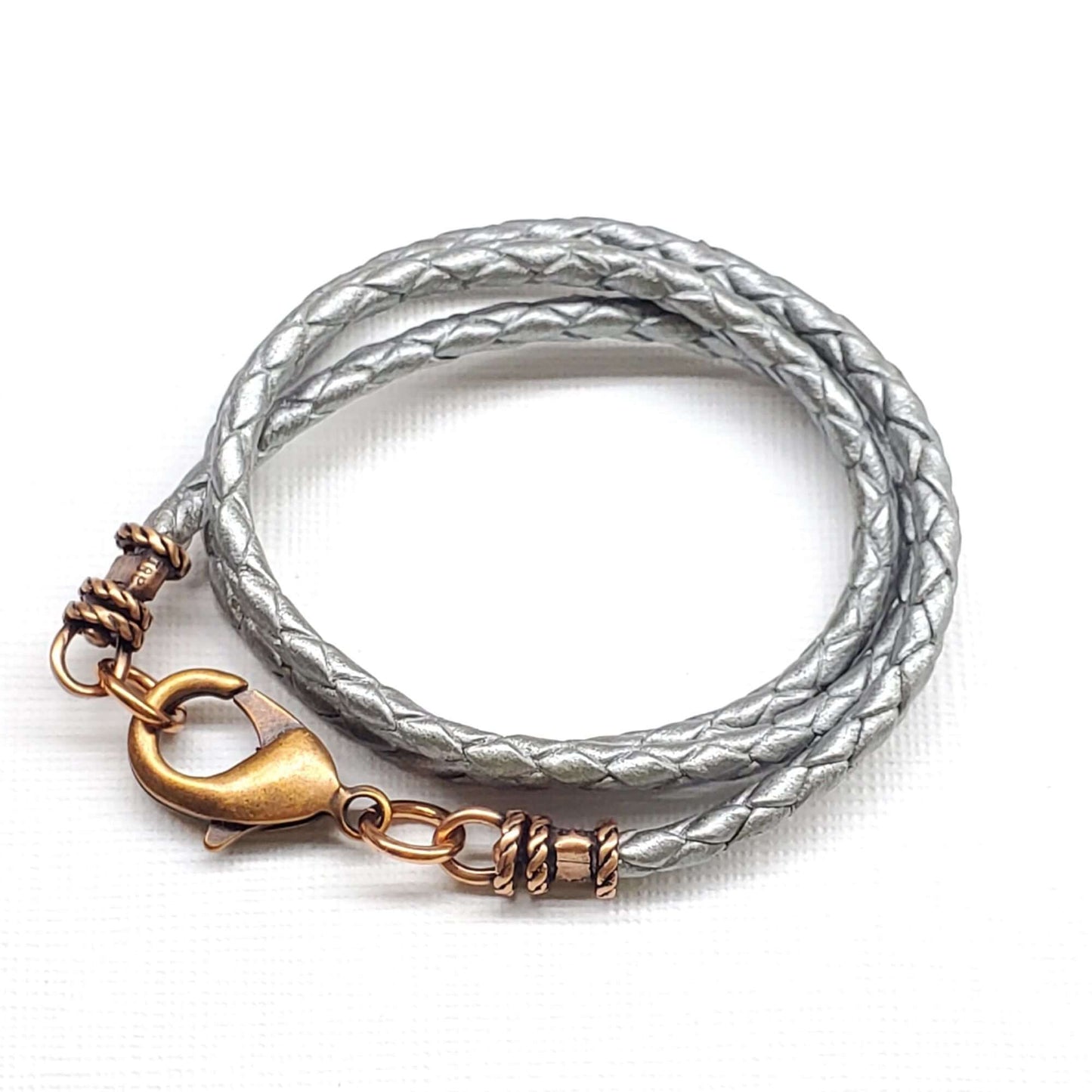 Silver braided leather  necklace with a bronze clasp on a white background