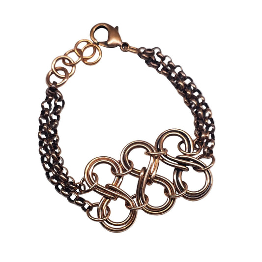 Bronze infinity chain bracelet on a white background