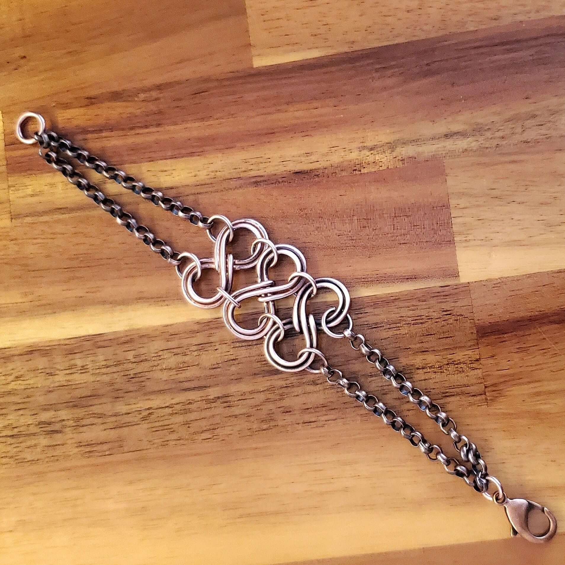 Silver chain bracelet on a wooden surface