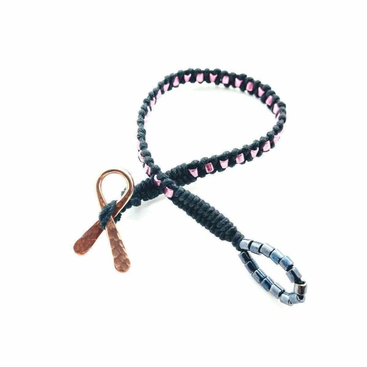 Bracelet with pink beads and leather elements on a white background