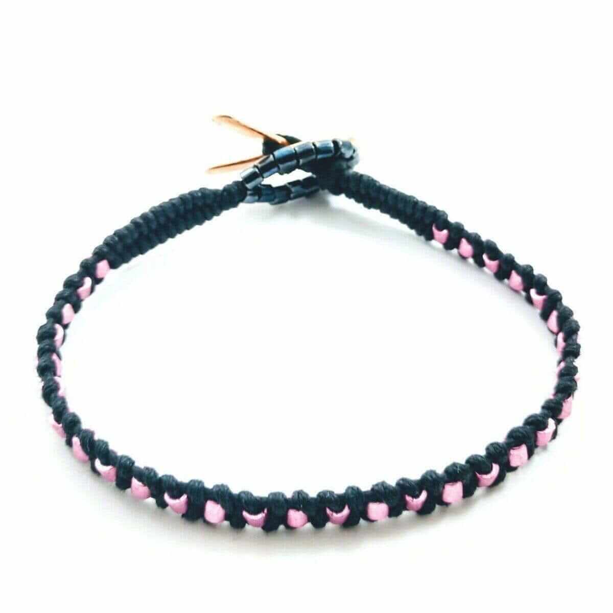 Black and pink beaded bracelet on a white background