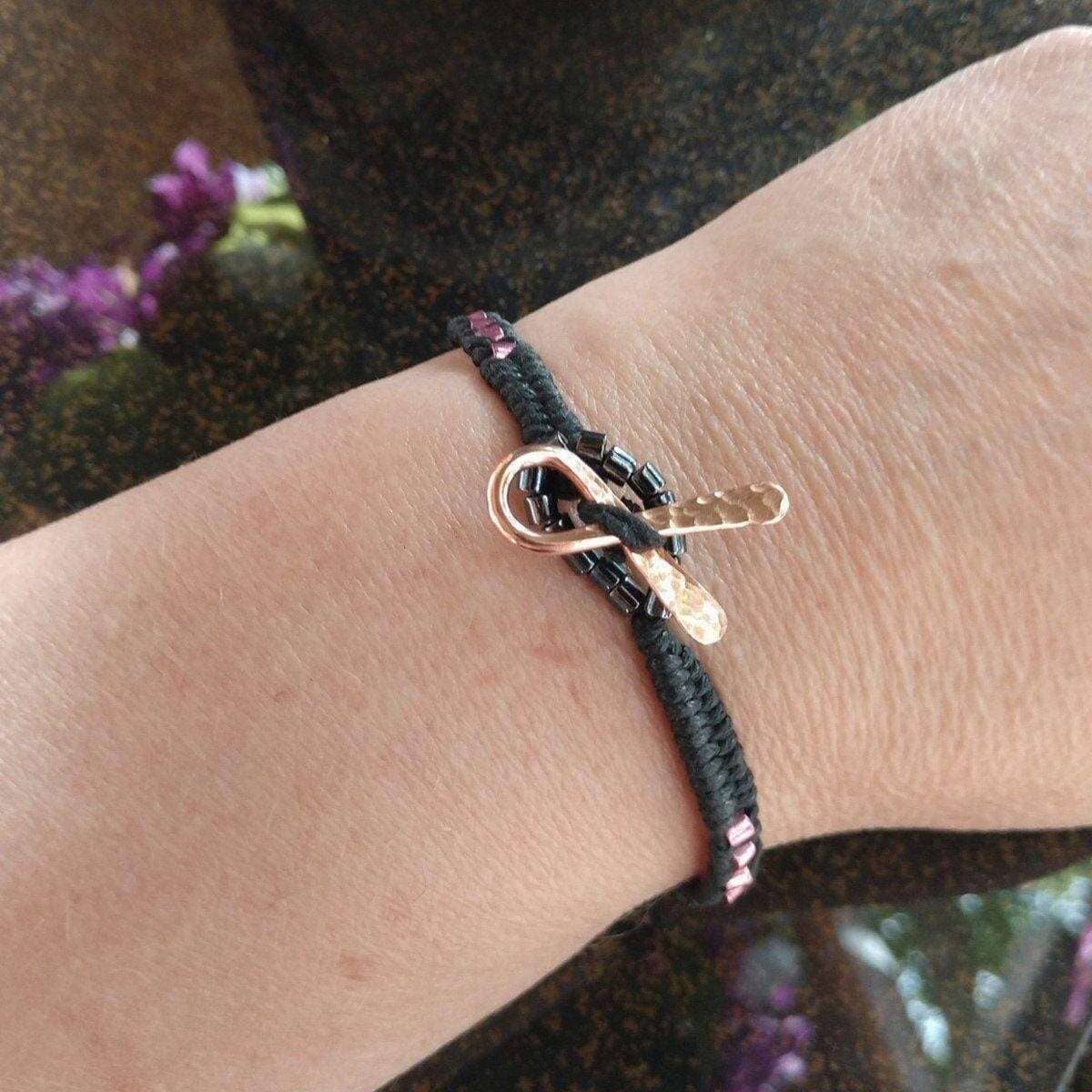 Bracelet with a unique clasp on a wrist, with a blurred background