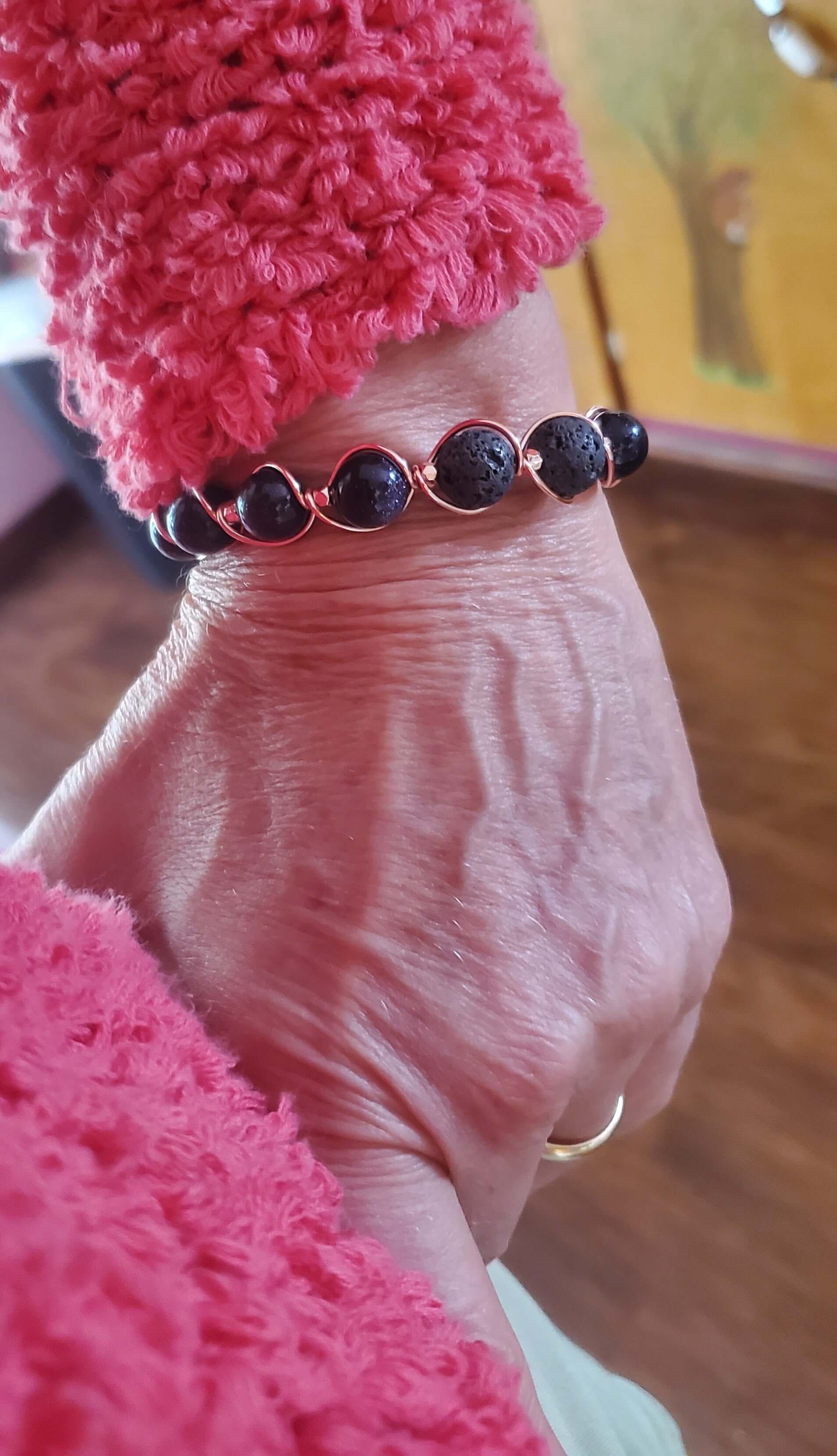 Close-up of a hand wearing a bracelet with a blurred background