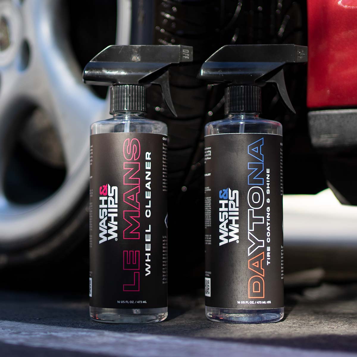 Two bottles of car care products, 'Le Mans' and 'Daytona', with a car in the background.