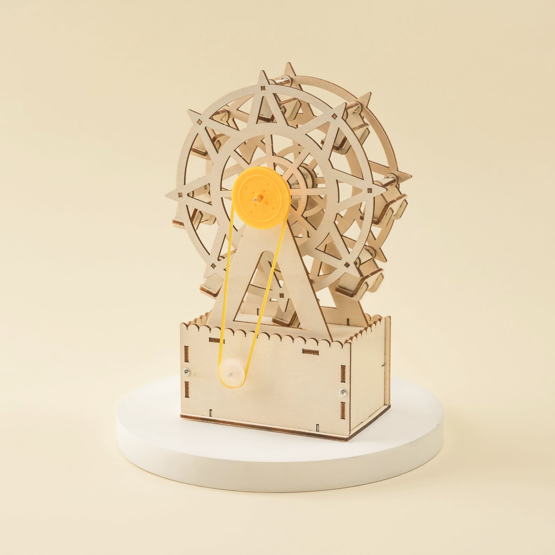 Wooden mechanical model of a Ferris wheel on a beige background