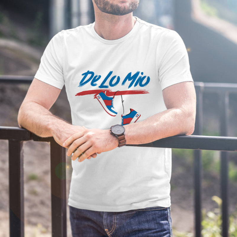 Man wearing a white t-shirt with 'De Lo Mio' design, standing outdoors.
