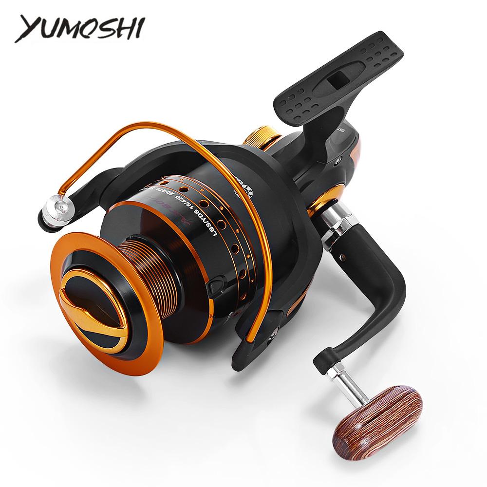 Fishing reel with black and orange design on a white background, featuring the brand 'YUMOSHI'.