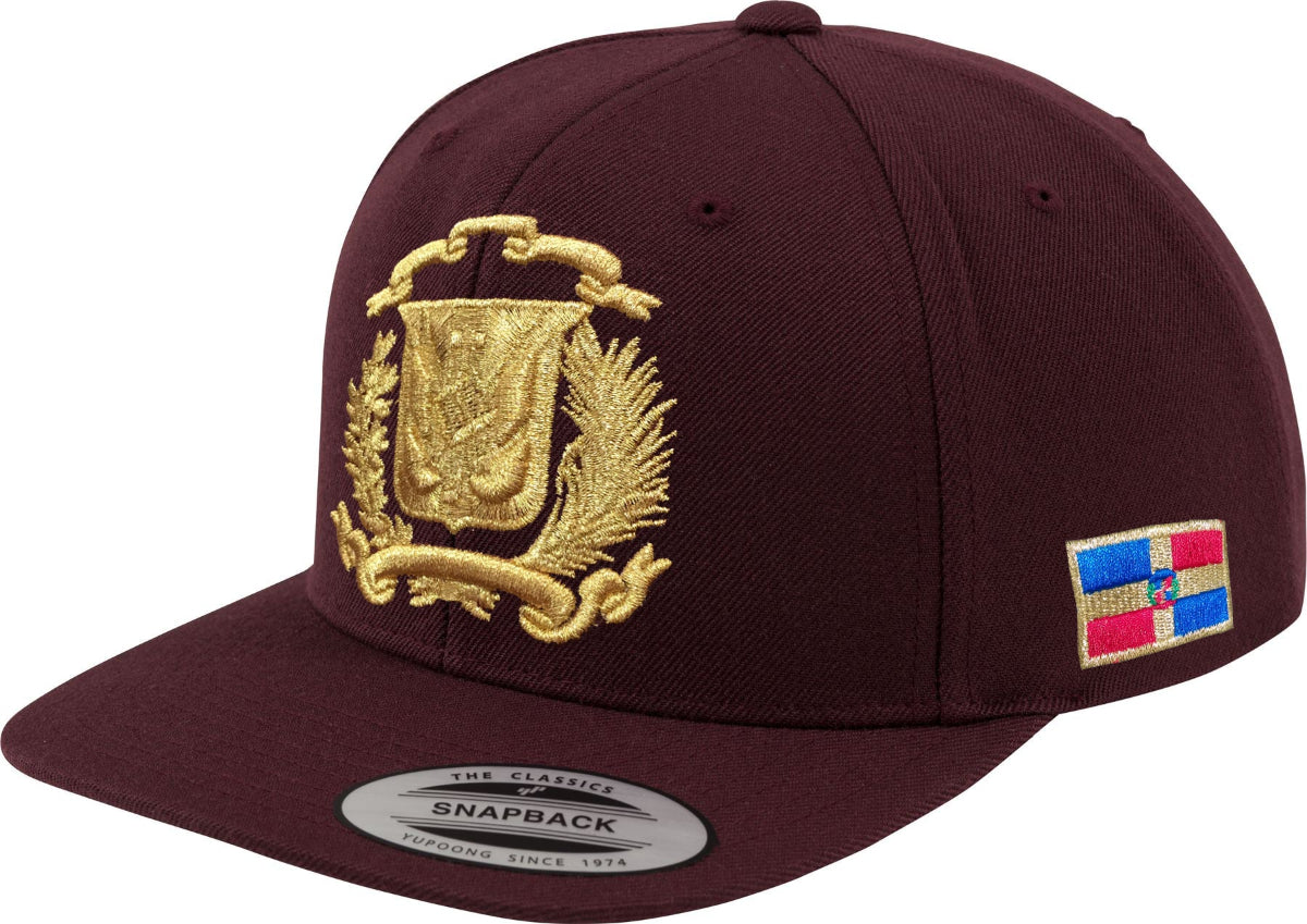 Maroon snapback cap with gold emblem and colorful patch on a white background