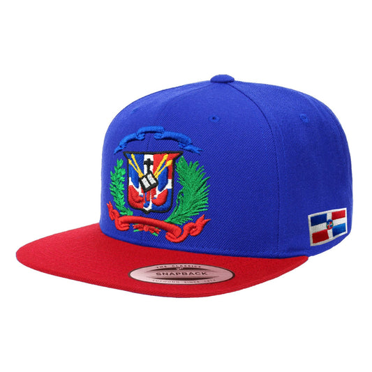 Blue and red snapback cap with a colorful Dominican emblem on a white background