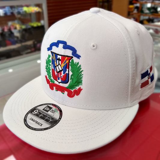 White cap with colorful Escudo Republica Dominicana (Dominican Shield) emblem and New Era logo on a red surface