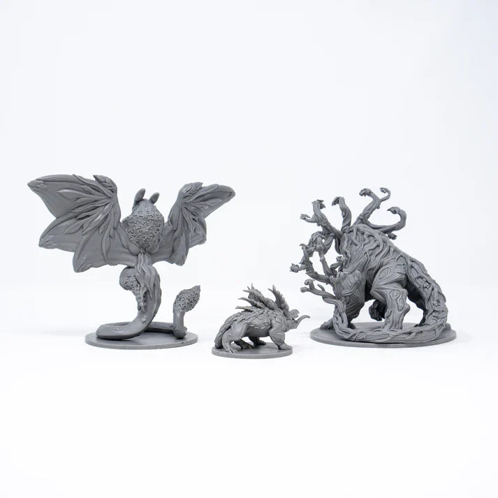 Three gray fantasy figurines on a white background