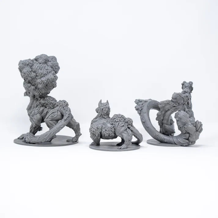 Three gray fantasy creature figurines on a white background