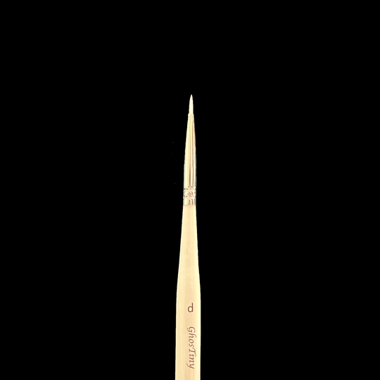 Paintbrush with a wooden handle on a black background