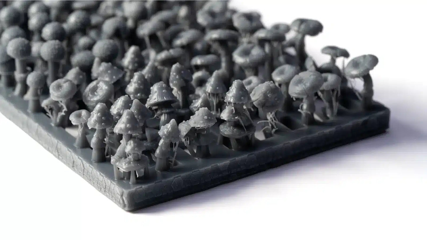 Collection of small gray 3D-printed figures on a white background