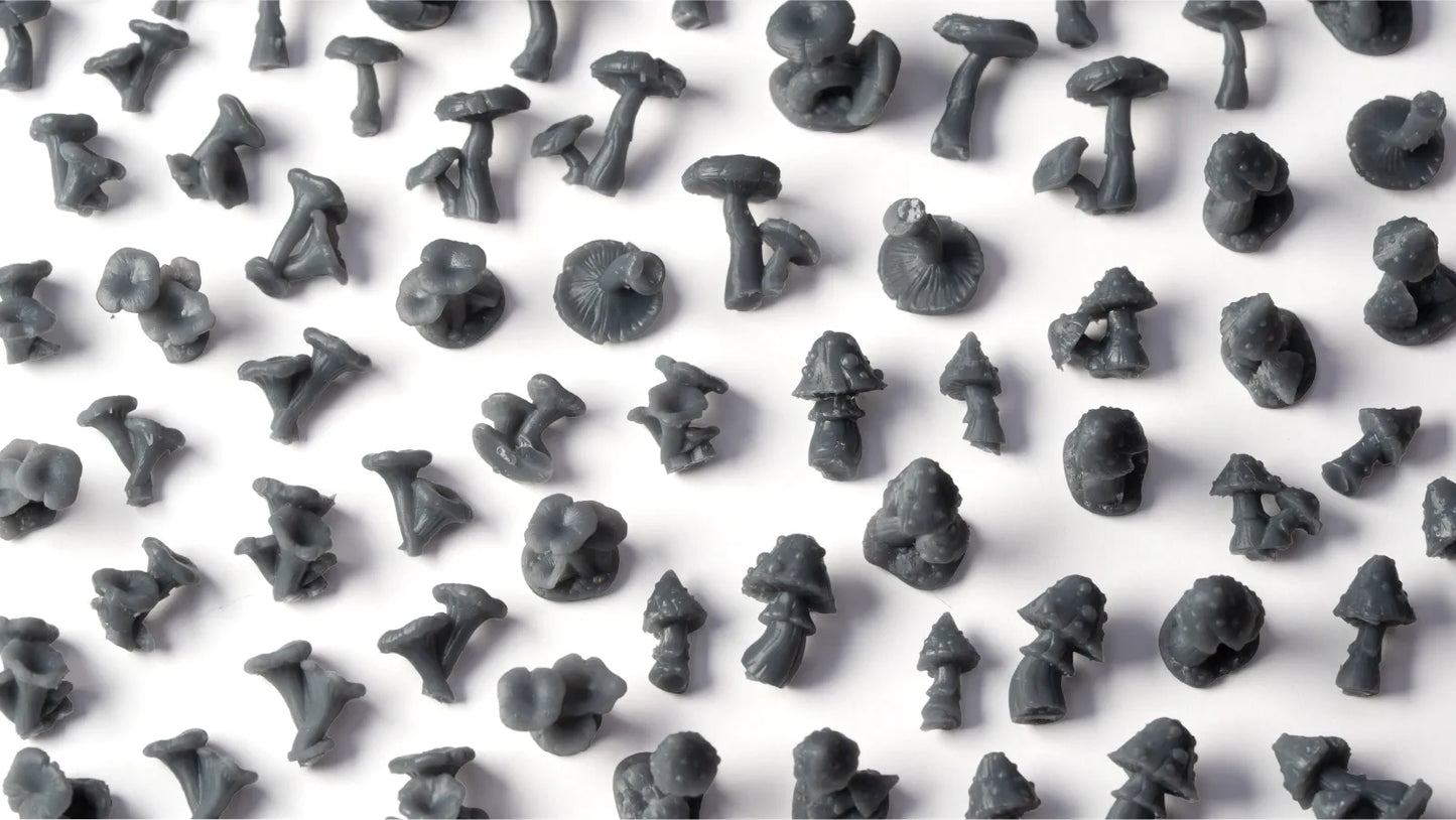 Pattern of small gray mushroom figurines on a white background