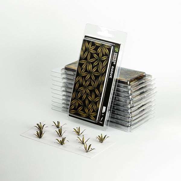 Stack of small transparent containers with green plant-like stickers on a white background