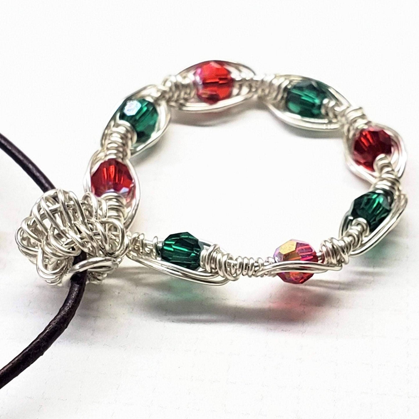 Bracelet with red and green beads on a white background
