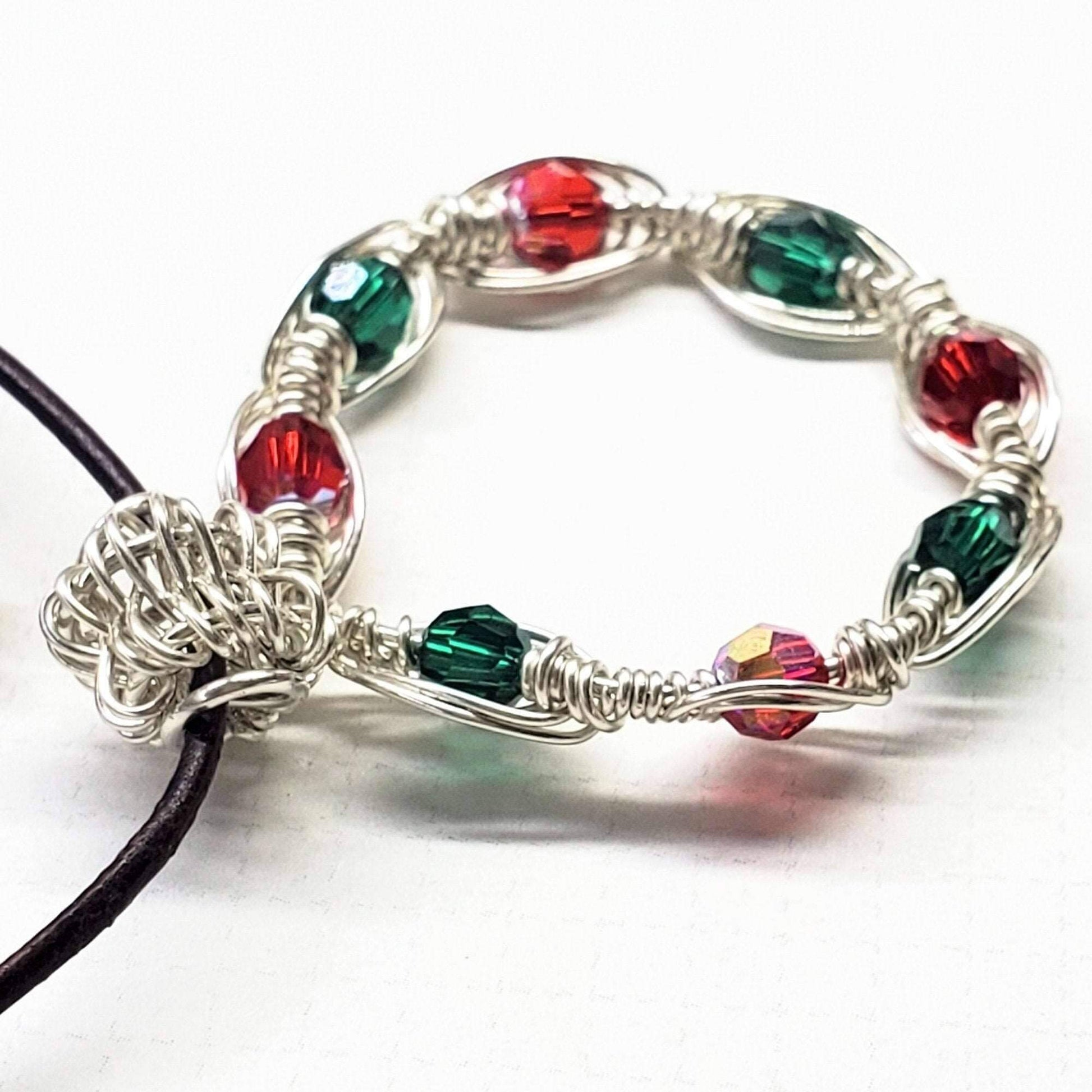 Bracelet with red and green beads on a white background
