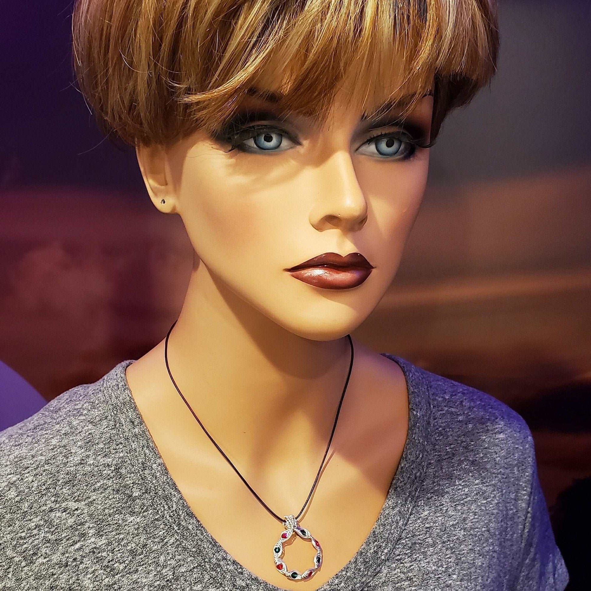 Mannequin head with a necklace on a blurred background