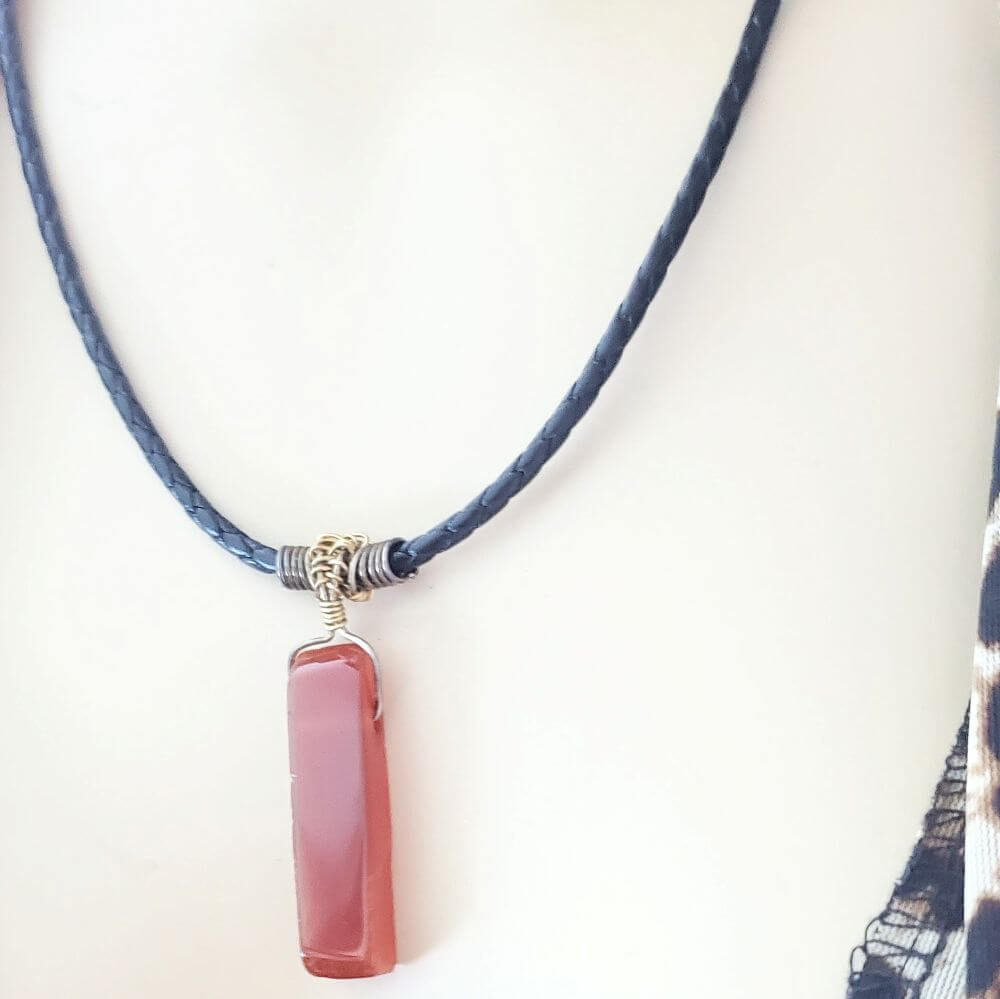 Necklace with a pink pendant on a white background